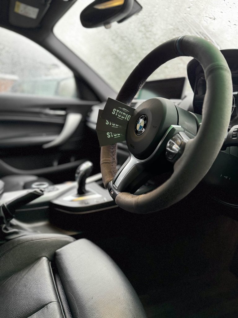 studio detailing business cards in bmw 135i after full valet completed in Crawley